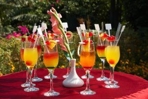 outdoor cocktail party with glasses served on table with red table-cloth